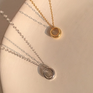Minimalist geometric circular pendant necklaces in polished gold and silver finishes