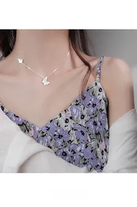 Close-up of elegant silver necklace featuring double butterfly pendants with white inlay