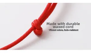Macro view of the durable red braided wax rope detail featuring firm knots and vibrant color
