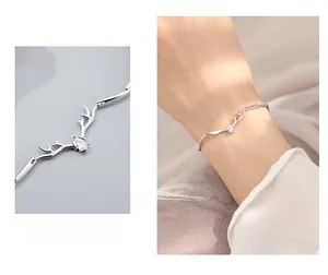 Detail of silver deer antler bracelet with water-drop zircon on female wrist