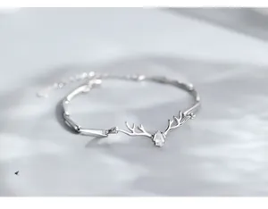 Macro view of 925 sterling silver deer antler bracelet with sparkling pear-cut stone
