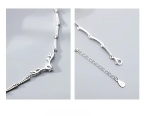 Macro detail of S925 sterling silver antler pendant with shiny cubic zirconia and bamboo chain