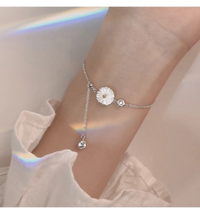 Detail of silver daisy bracelet with white shell petals and sparkling zircon stones
