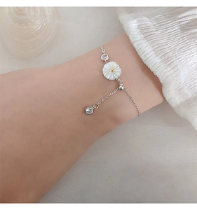 Silver daisy flower bracelet with sparkling crystals worn on wrist for a fresh look