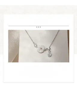 Detail view of silver daisy bracelet with white shell flower and cubic zirconia accents