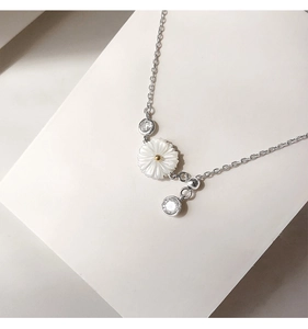 Detail of silver daisy bracelet with white shell petals and sparkling zircon accents