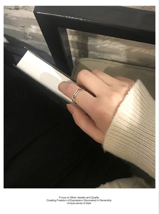 Detail showing the double-layered silver V-shaped minimalist ring on a hand