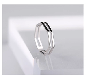 Macro shot of 925 sterling silver geometric hexagonal double-layer ring on acrylic block