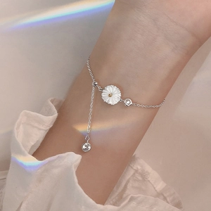 Elegant sterling silver daisy bracelet with sparkling stones on a woman's wrist