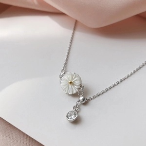 Elegant sterling silver daisy necklace with shell petals and sparkling zircon pendant