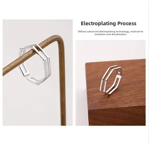 Detail of silver geometric double-layered hexagonal open ring with electroplating finish