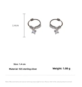 Detail of S925 sterling silver huggie earrings with round cubic zirconia pendants