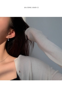 Detailed view of s925 silver hoop earrings with shimmering zircons on a female model