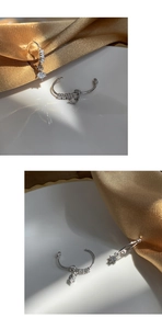 Detailed view of S925 silver hoop earrings with sparkling cubic zirconia charms