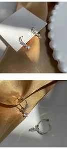 Close-up of S925 silver hoop earrings with micro-pave crystals and sparkling zircon drops
