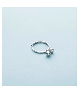 Macro shot of polished S925 sterling silver ring featuring two minimalist small metal bells