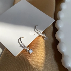 Minimalist S925 silver hoop earrings with cubic zirconia charms on elegant display