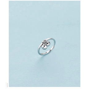 Detail view of S925 sterling silver open ring featuring two small round bead charms