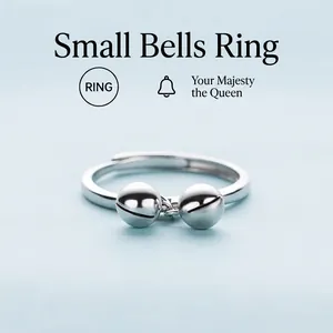 Minimalist S925 sterling silver open ring featuring two polished bell charms on light blue