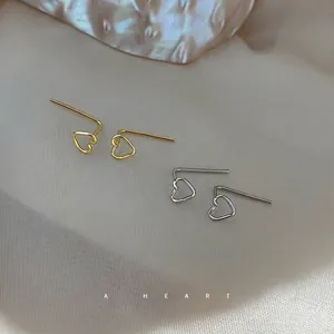 Minimalist hollow heart silver drop earrings in gold and silver finishes on satin