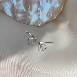 Minimalist sterling silver hollow heart earrings on elegant silk with shell decor