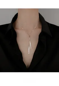 Close-up of S925 silver geometric triangle necklace on a model with black shirt