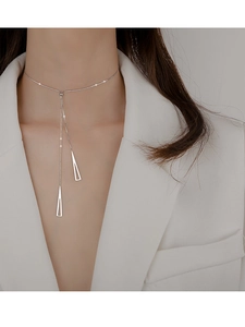 Detail of silver S925 geometric triangle Y-necklace on female model in white suit