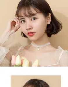 Detail of elegant semi-circular pearl earrings with diamonds on a model with lace choker