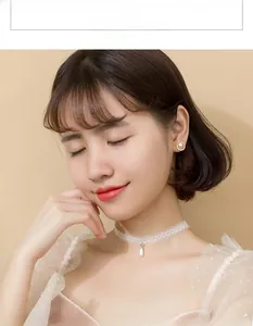Detailed close-up of a semi-circular silver pearl earring on a model with elegant styling