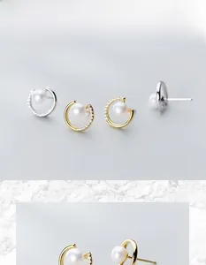 Detailed macro view of S925 silver crescent earrings with pearls and micro-diamonds