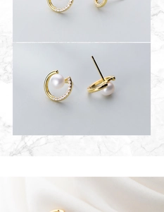 Macro detail of S925 silver semi-circle earrings with pearl and shimmering zircon stones