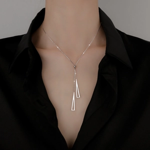 Minimalist S925 silver necklace with double geometric triangle pendants on a black shirt