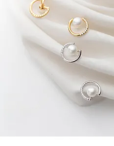 Close-up of S925 silver semicircular pearl stud earrings with zircon inlay detail