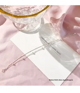 Detail of S925 sterling silver double-layer bracelet on elegant silk background