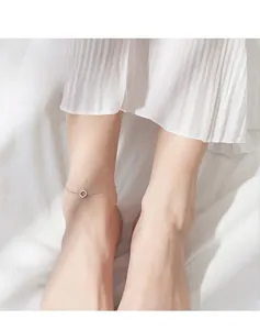 Detailed view of an S925 sterling silver geometric ring anklet worn on a female ankle