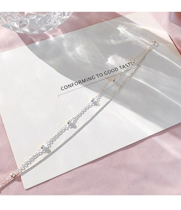 Detailed macro view of silver double-layer bracelet with bead accents and snake bone chain