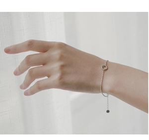 Minimalist square geometric silver bracelet detail with delicate chain and adjustable clasp