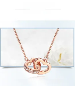 Detail of rose gold S925 sterling silver interlocking heart necklace with zircon stones
