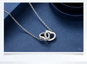 Close-up of interconnected double heart necklace with micro-pave cubic zirconia crystals