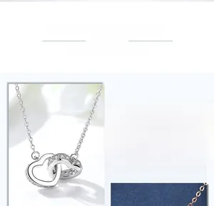 Detailed view of intertwined double heart pendants with crystals and polished finish