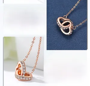Detail of rose gold double heart pendant with sparkling pavé cubic zirconia inlay