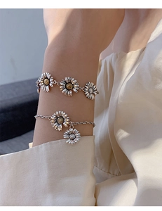 Detailed macro view of S925 sterling silver daisy bracelets with retro finish on a wrist