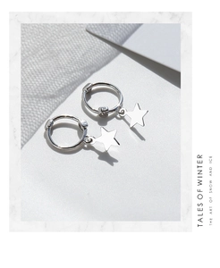 Detailed view of S925 sterling silver hoop earrings with polished star pendants