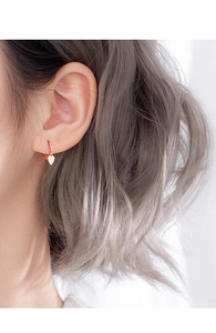 Elegant 925 silver heart dangle earrings shown on model for a minimalist jewelry look
