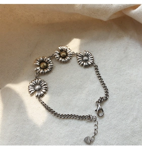 Detail of S925 sterling silver daisy bracelet with vintage finish and lobster clasp