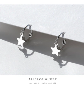 Detail of minimalist 925 sterling silver star hoop earrings on white background display
