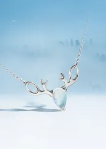 Close-up of s925 silver elk horn necklace featuring a glowing teardrop moonstone