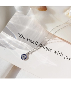 Detailed close-up of s925 silver evil eye necklace with blue and white zircons