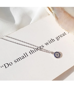 Detailed close-up of s925 silver evil eye pendant with blue gemstones and white stones