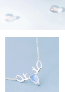 Macro shot of silver deer antler necklace with blue moonstone waterdrop pendant